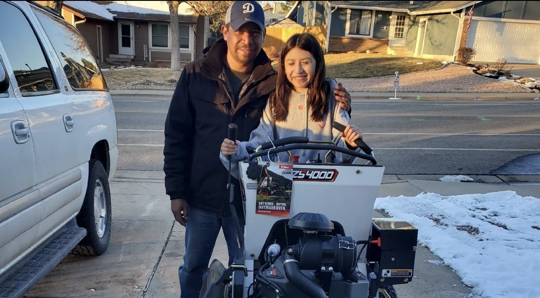 Luis and his daughter with new Aurora Lawn Service equipment